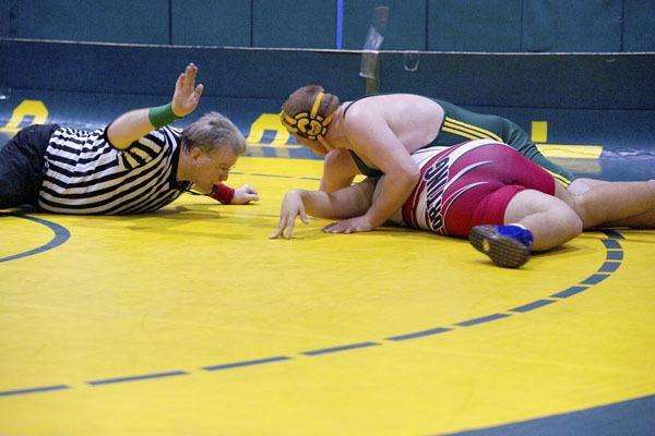 The referee signals the pin