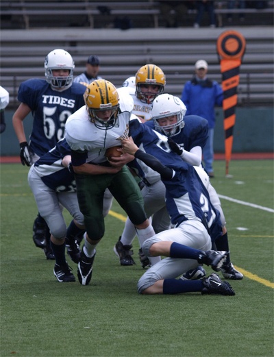 Owen Brenno protects the ball as five Tide players try to bring him down.