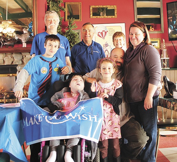 The Hartness family and Make-A-Wish volunteers at a farewell party at The Rock last week. Clockwise from top left: Make-A-Wish volunteers Ken Kieffer and AJ Thibeault