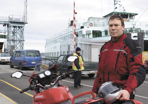 Toby Holmes saves on ferry fares by commuting on a motorcycle to his job on Seattle’s Capitol Hill.