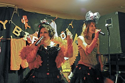 Tami Brockway Joyce and Jennifer Sutherland — aka the Washington State Fairies — entertain the crowd at Fairyoke last Friday.