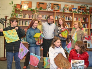 Harbor School students show off some of the pieces that will be auctioned off on Saturday. They are