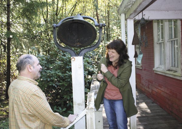 Kathy Johnson rings the bell in front of the house she shares with her husband Phil.