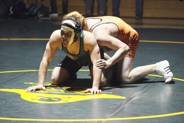 Shane Armstrong looks for the referee’s signal for a restart in his 182-pound match with Decatur’s Spencer Smith on Dec. 13. After having a minor cut on his face patched up