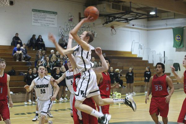 Pirate freshman Jessie Norton draws a foul as he goes to the basket early in Vashon’s 70-26 win over Orting.