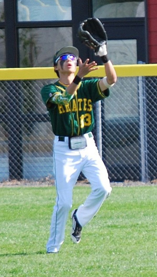 Center fielder Simon Perrin catches a pop fly in action against Charles Wright.