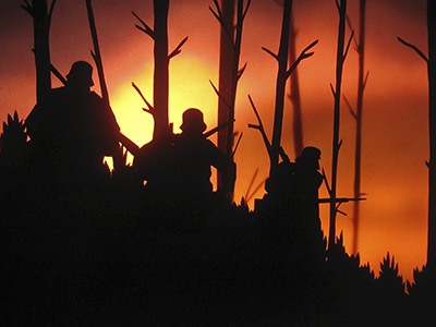 Animated soldiers can be seen walking among trees in this screenshot from “And We Were Young