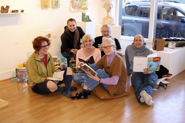 VALISE Gallery members peruse a collection of banned books that is part of the gallery’s current all-Island show based on the theme of censorship.