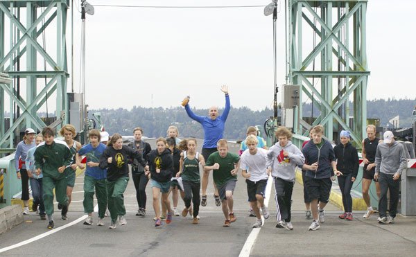 Vashon High School and McMurray cross country runners lead parents and community supporters from the Tahlequah dock to start Saturday's Ferry to Ferry run