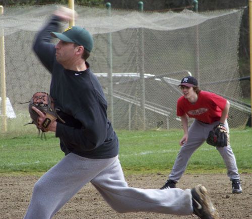 Greg Applegate pitches at Saturday’s alumni baseball game.