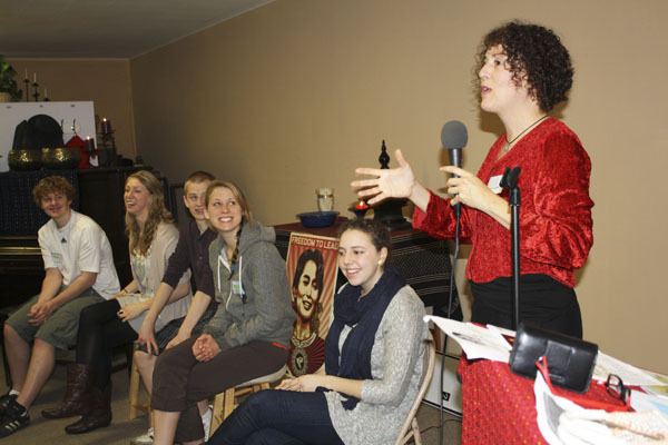 Leslie Brown/Staff Photo Alix Clarke speaks to the Unitarian Fellowship at Lewis Hall last month while members of the Amnesty Club listen and laugh. From left