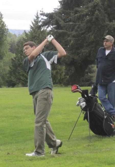 Scott Smith sends his golf ball sailing towards the green.