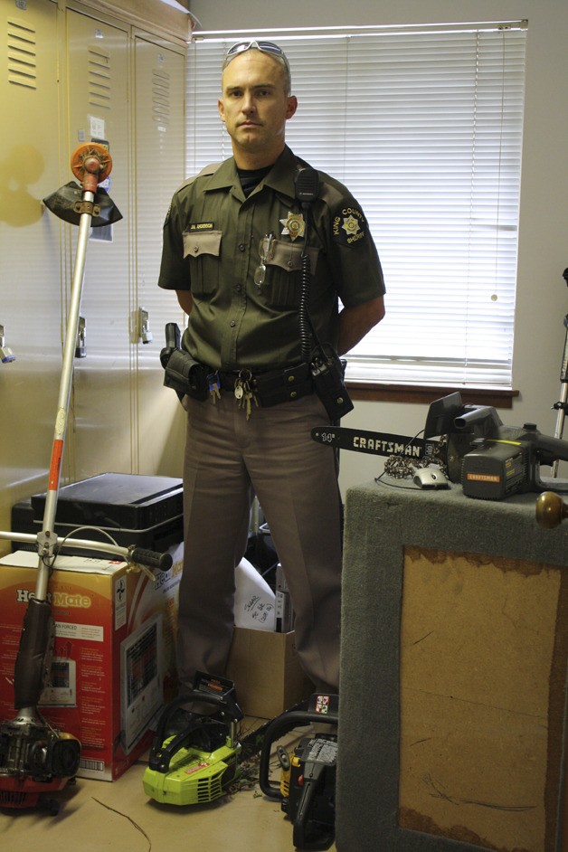 Dep. Joel Anderson stands among some of the stolen goods