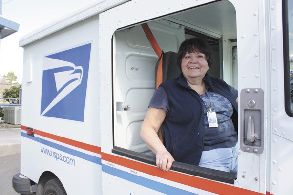 Carrier Marilyn Ripley sits behind the wheel of one of the new trucks.