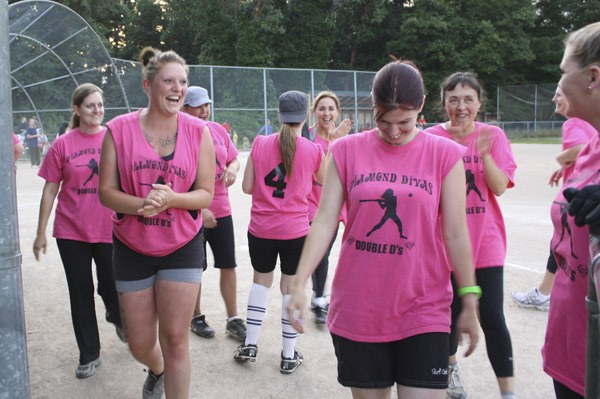 Members of the Diamond Divas softball team celebrate a successful inning during a game at Vashon High School last Thursday evening.