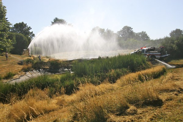 VIFR crews finish putting out a brush fire on Maury Island on Wednesday