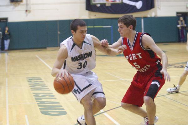 Dan Lofland (30) tries to go around Port Townsend's Robert Ristick as the clock winds down in Vashon's 60-41 win in the home opener.