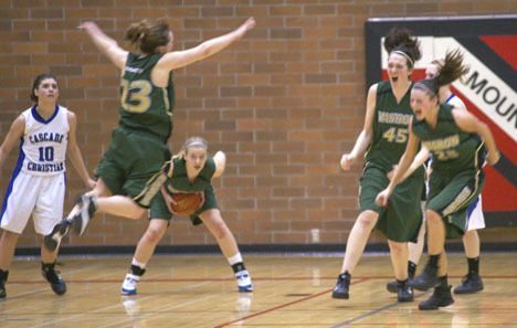 The final buzzer sounds and the celebrations begins as the Pirates just won their way into the state tournament. From left are Kiki Means