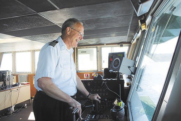 Natalie Johnson/Staff Photo Captain David Wilson sails the Issaquah last Friday