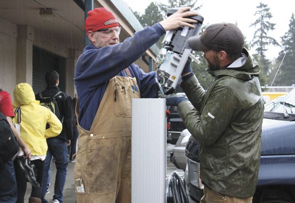 Casey Lawrence and Jason Williams of Artisan Electric install the new electric vehicle charging station at VHS last week.