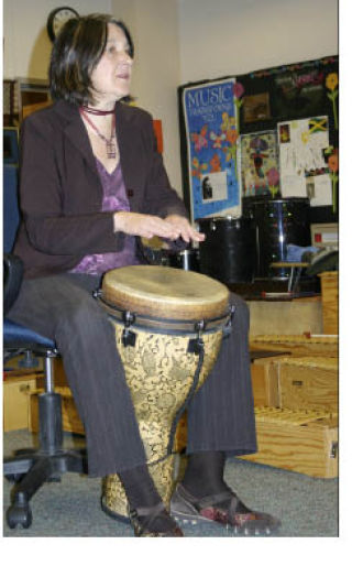 Carolyn Candy leads a second-grade class in a call-and-response exercise on the conga drums.