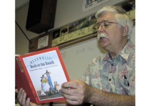 Loren Hill reads to his students on his second-to-last day of teaching.