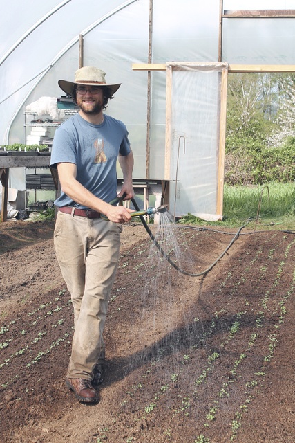 Anneli Fogt/Staff PhotoLiam Rockwell waters plants in his greenhouse he built last year. He is one of the island’s newest and youngest farmers and will be selling his vegetables at the farmers market in May.