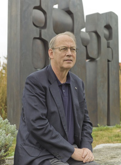 Tom Bangasser in front of the famed sculpture by Julie Speidel