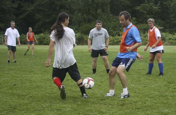 Members of the new adult soccer league compete at The Harbor School fields earlier this month.