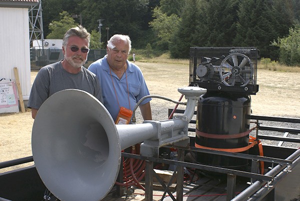 Kevin Britz (left) and Capt. Joe Wubbold show the ‘new’ foghorn that will be on display at the Point Robinson Lighthouse. The horn originally was on the former USS Bridge