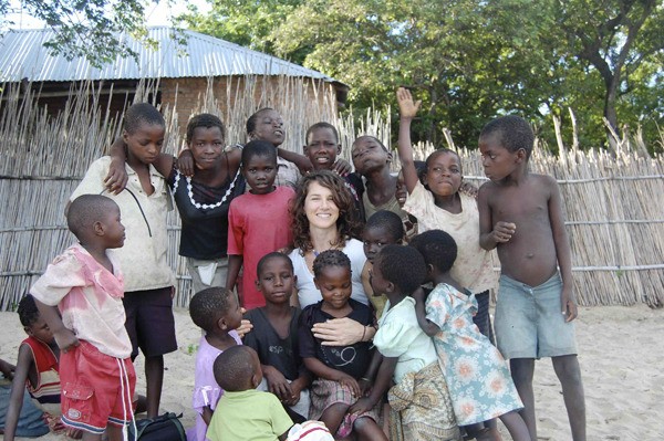 Some of the children of Nkhandwe Village in Malawi surround Olivia Pendergast