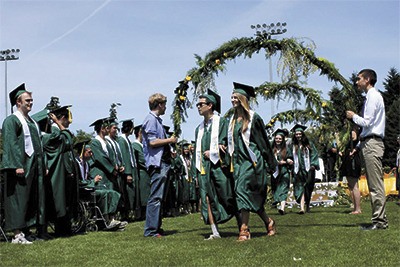 Graduates Jonathan Kim and Madelyn Royal walk together in the graduation processional. They are followed by Emma Hennessey and Katherine Misel.