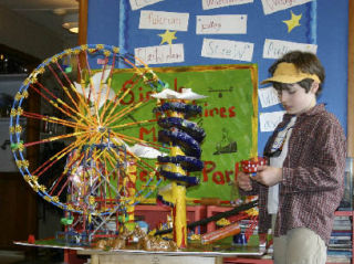 First-grader Coleman Papa-Musgrave demonstrates how he used a fulcrum and a lever to make a seesaw that can entertain two mice.