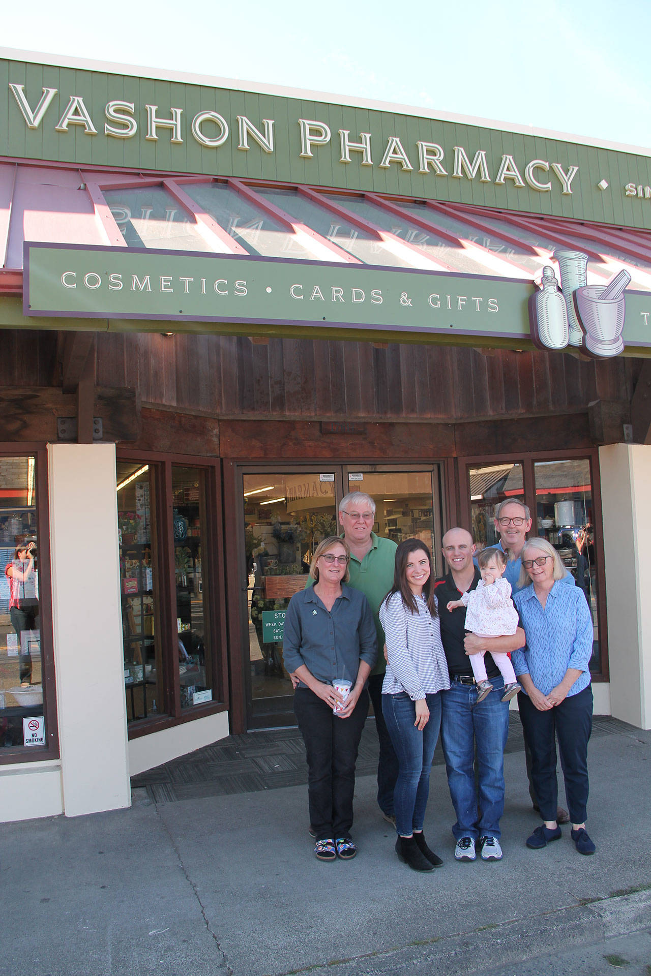 Left to right, former Vashon Pharmacy owners Myra and Dave Willingham; new owners Amy and Tyler Young with their 1-year-old daughter, Alivia; former owners Tom and Mary Langland. (Anneli Fogt/Staff Photo)