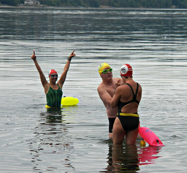 Heidi Skrzypek (left), Curtis Vredenburg (center) and Kate Curtis prepare for a swim last week in Vashon’s Paradise Cove. They are part of a four-person relay team that will cross the English Channel to benefit the People For Puget Sound program. (Paul Rowley/Staff Photo)