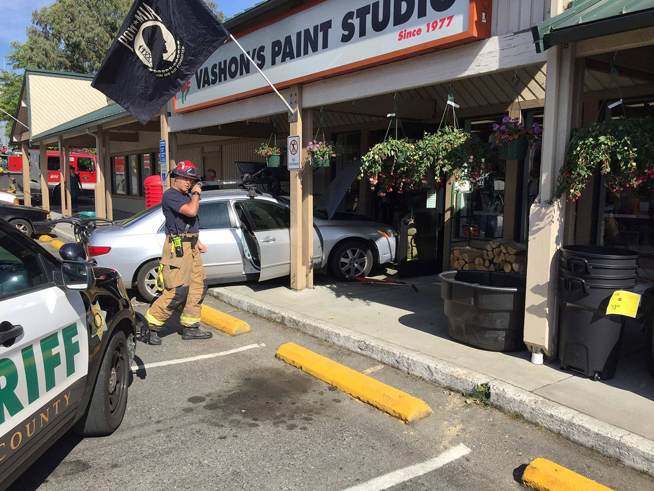 The scene of a minor car accident Saturday morning in the Thriftway parking lot is roped off as aid crews evaluate the driver (John Simonds Photo).