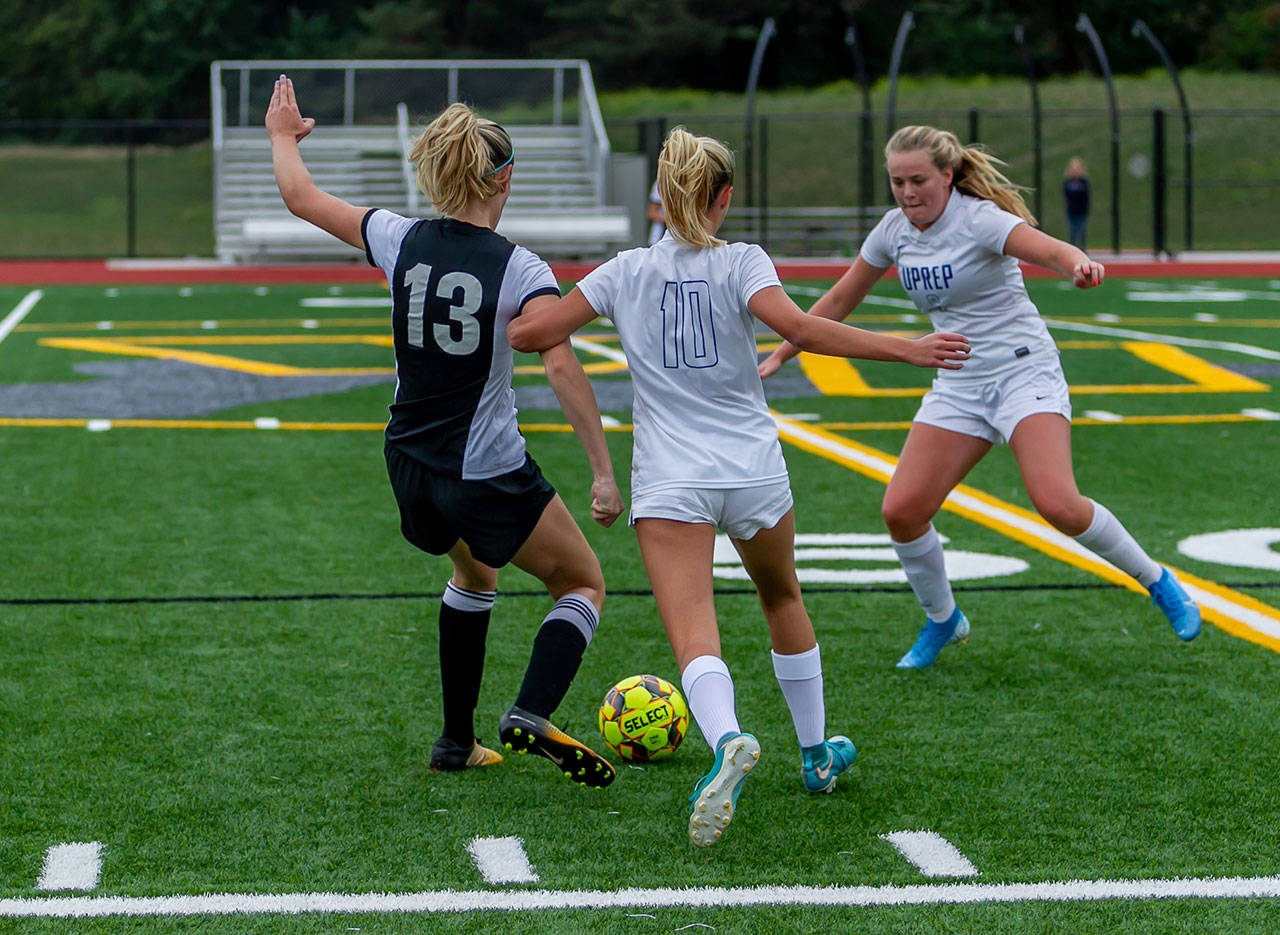 Payton Venturi, number 13, heads for the goal while fending off two SAAS players (John Sage/FinchHaven Photo).