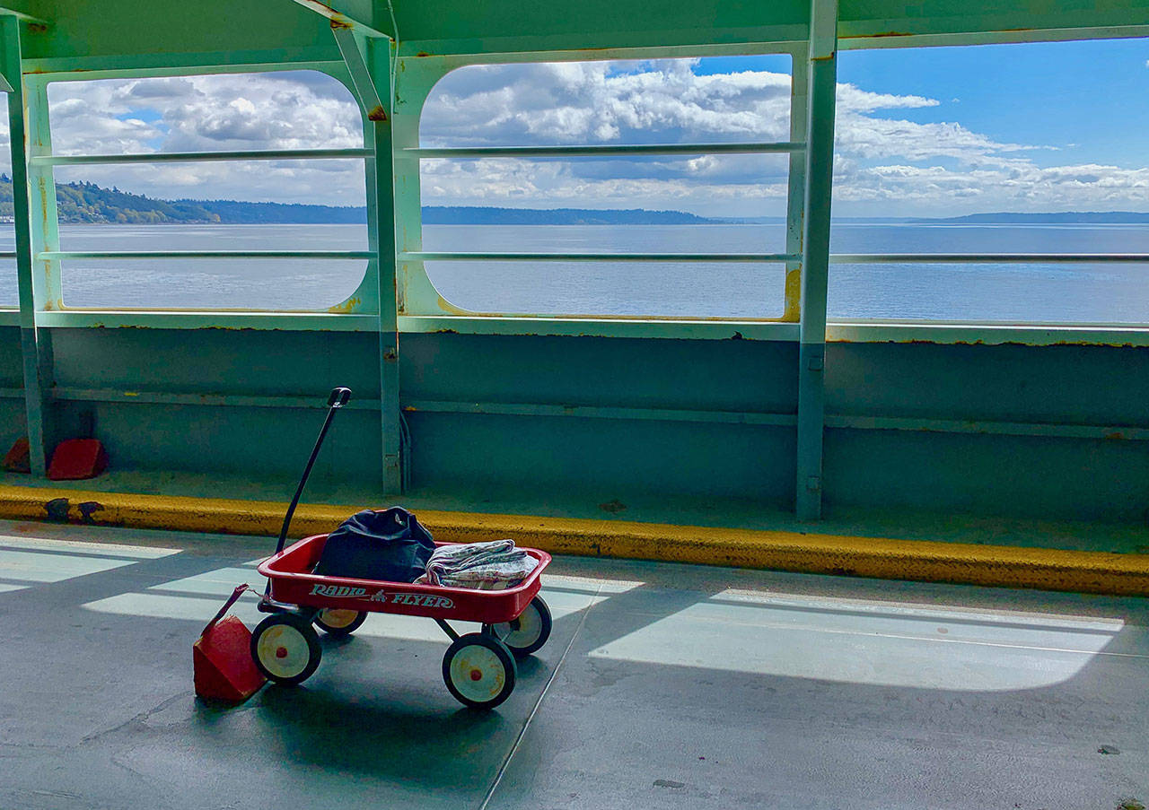 A lone red wagon waits for its destination crossing Puget Sound last weekend. Washington State Ferries said that recent system-wide ridership has been down about 75 percent compared to the last week of February (Tara Morgan Photo).
