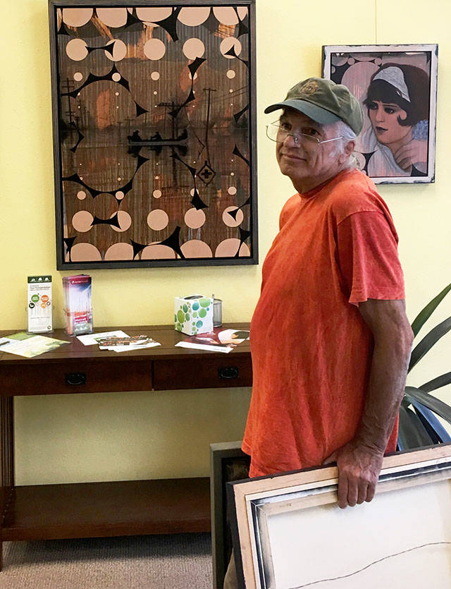 Jack Chevalier, a longtime islander whose artwork was included in many museum exhibitions and collections, hung his work in 2017 for a local show at Puget Sound Cooperative Credit Union (Courtesy Photo).