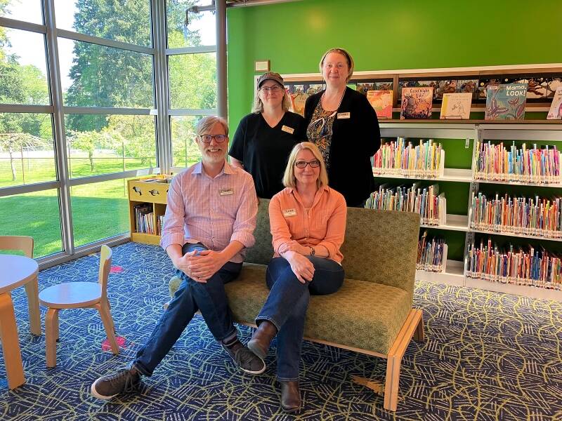 Vashon Library staff members Steven Bailey, Kay Hermanns (seated left to right) Chelsea Marx and Nita Dickerson (standing left to right) are now welcoming islanders back to the library during expanded hours of operation (Elizabeth Shepherd Photo).