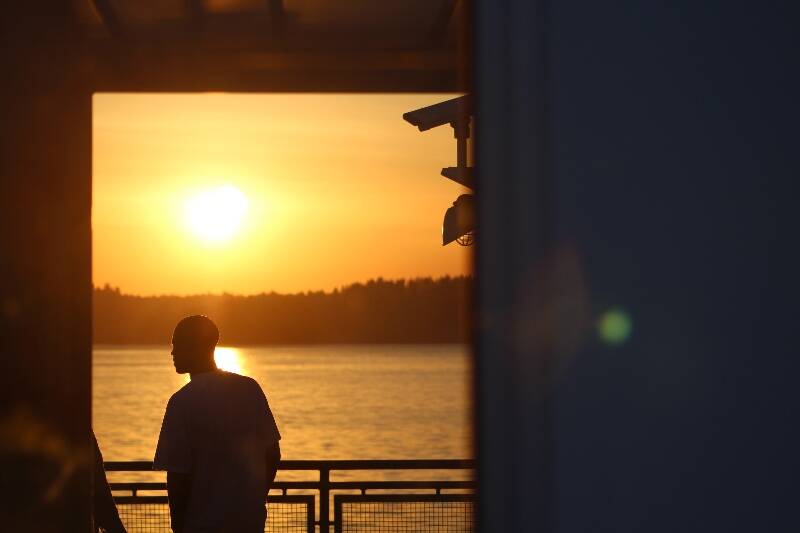 A passenger rides a ferry heading toward Pt. Defiance on a September evening (Alex Bruell photo).