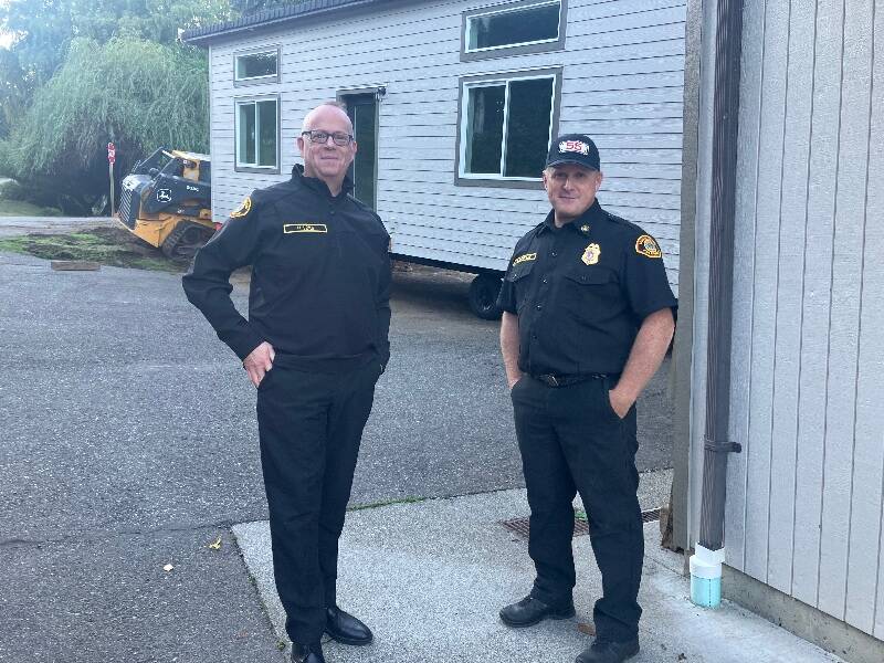 Last Thursday, Fire Chief Matt Vinci (left) and Division Chief Ben Davidson greeted the delivery of a two-bedroom modular housing structure that is now being readied in preparation for the reopening of the Burton Fire Station as of Nov. 1 (Elizabeth Shepherd Photo).