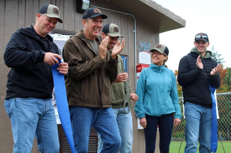 Community members celebrate a ribbon cutting at the new AED SaveStation at the VES fields. Alex Bruell photo