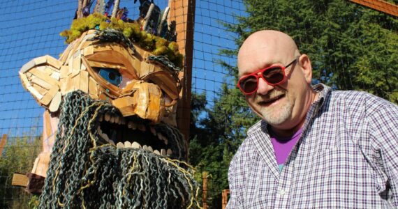 Matt Beursken smiles next to the headpiece of Edgar the Forest King, his Thomas Dambo-inspired troll costume. Alex Bruell photo