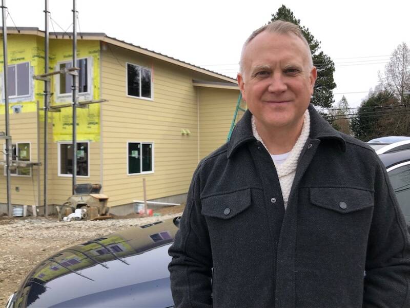 Jason Johnson, executive director of the nonprofit Vashon HouseHold, stands outside the upcoming Island Center Homes development (Mary Bruno Photo).