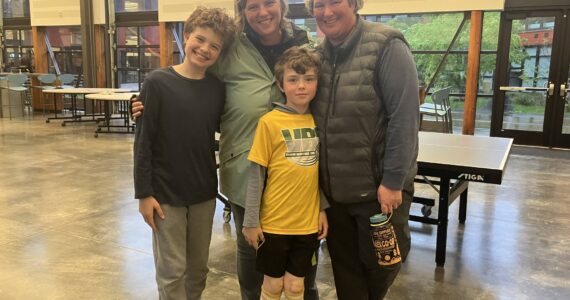 Elizabeth Shepherd Photo
Parents Lindsey and Leigh Anne McKeen, and their children Sabin (left) and Salinger (center) mustered smiles for The Beachcomber after Sabin and Salinger — both students at Chautauqua Elementary School — asked the school board and superintendent not to cut staff they said had helped them learn and grow.