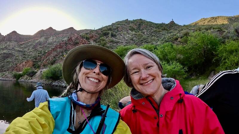 Heidi Skrzypek (left, support kayaker) and Mary Singer (right, swimmer) smile for the camera at Apache Lake (Heidi Skrzypek photo).