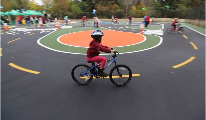 Riders of all ages can practice bicycle proficiency and traffic rules at the “Traffic Garden” bicycle playground at Dick Thurnau Memorial Park, 3.5 miles from the Fauntleroy ferry dock. The park, which has parking, is at 11050 10th Avenue SW, in White Center. It’s open on Wednesdays and Thursdays from 10 a.m. to 1 p.m. and on Saturdays from 9 a.m. to noon. The park is closed on Sundays, Mondays, Tuesdays and Fridays (Photo via PublicHealthInsider.com).
Photo via PublicHealthInsider.com
Riders of all ages can practice bicycle proficiency and traffic rules at the “Traffic Garden” bicycle playground at Dick Thurnau Memorial Park in White Center, 3.5 miles from the Fauntleroy ferry dock. The park, which has parking, is at 11050 10th Avenue SW, Seattle 98146. It’s open Wednesdays and Thursdays from 10 a.m. to 1 p.m., and on Saturdays from 9 a.m. to noon. The park is closed Sundays, Mondays, Tuesdays and Fridays.