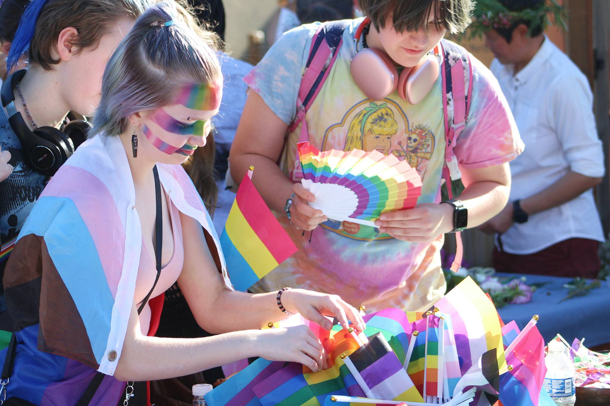 Young people select from a variety of flags at the June 7 Pride Street Dance next to Vashon Theatre. Alex Bruell photo.