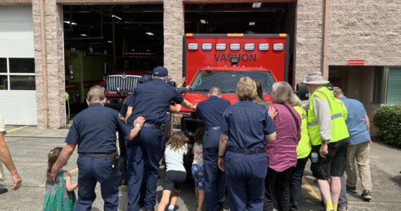 Elizabeth Shepherd Photo
Islanders help first responders push a new ambulance into Station 55, on Bank Road, during a firehouse ceremony that dates back to the 1800s.
